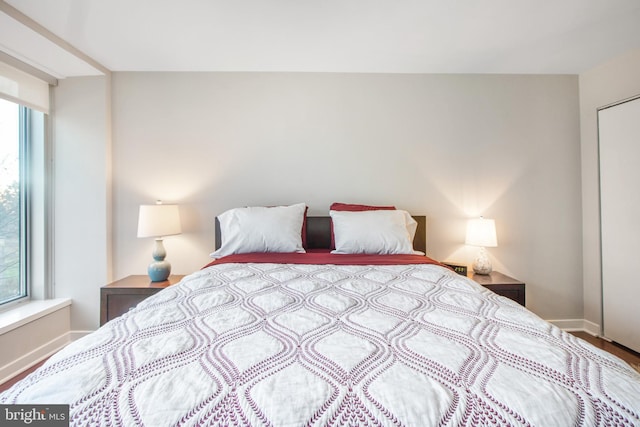 bedroom with baseboards and wood finished floors