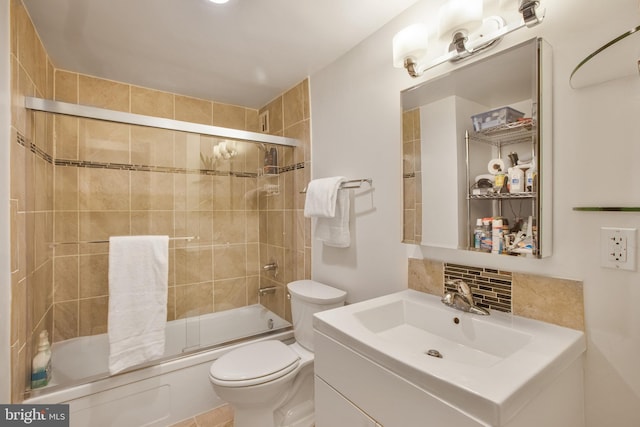 full bathroom with vanity, decorative backsplash, toilet, and shower / bath combination with glass door