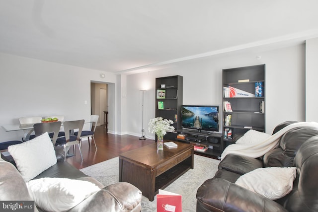 living area featuring baseboards and wood finished floors