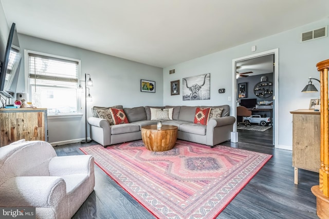 living room with baseboards, ceiling fan, visible vents, and wood finished floors