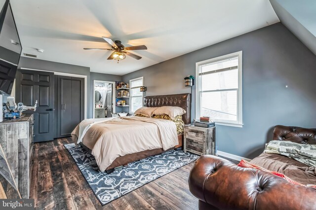 bedroom with a ceiling fan, dark wood-type flooring, baseboards, and vaulted ceiling