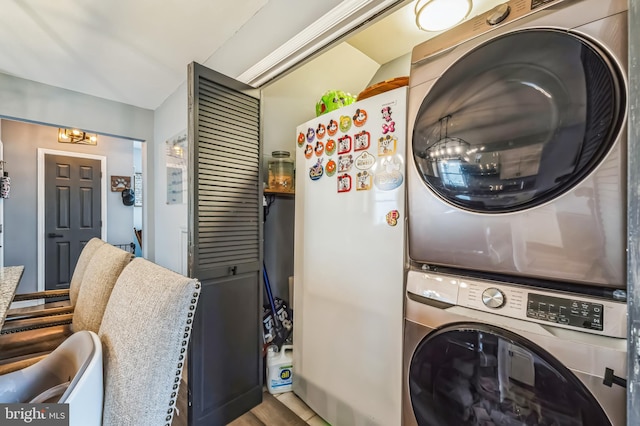 washroom with stacked washer and dryer and laundry area