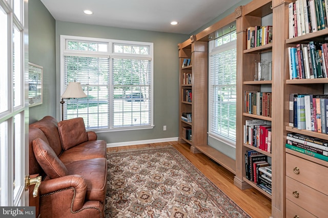 living area with wood finished floors, baseboards, plenty of natural light, and recessed lighting