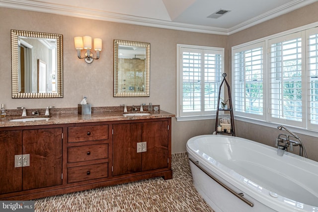 bathroom with ornamental molding, a freestanding tub, double vanity, and a shower