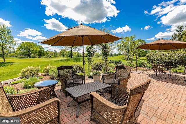 view of patio / terrace with outdoor dining space and view of golf course