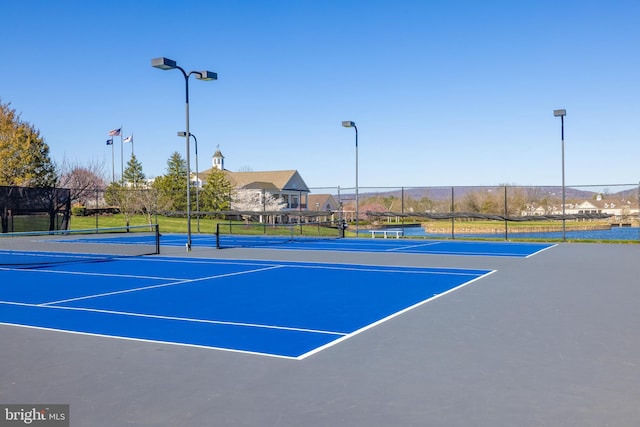 view of tennis court featuring fence