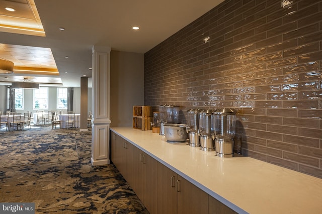 bar area featuring a tray ceiling, tasteful backsplash, and recessed lighting