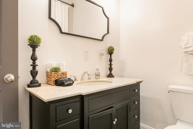 bathroom featuring toilet and vanity