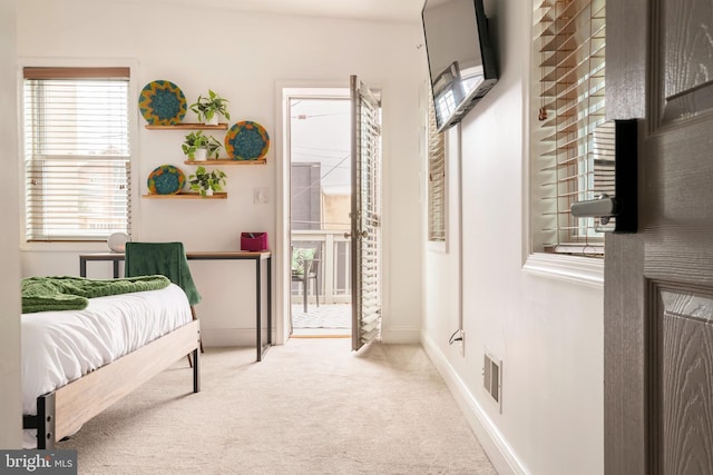 bedroom with baseboards, carpet floors, access to exterior, and visible vents