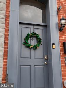 doorway to property with brick siding