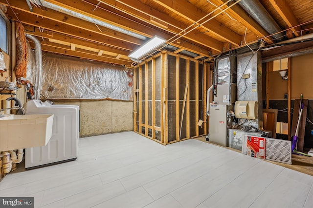 206 Fairgrove Cir, Gaithersburg, MD 20877 - unfinished below grade area featuring washing machine and clothes dryer, a sink, and heating unit