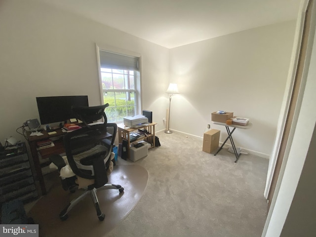 carpeted office featuring baseboards