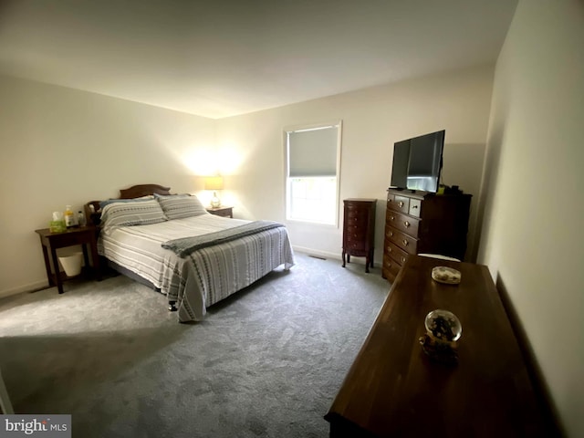 carpeted bedroom featuring baseboards