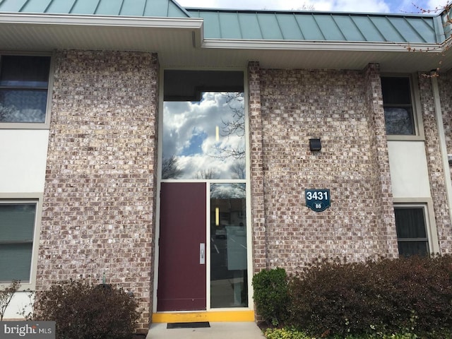 3431 S Leisure World Blvd Unit 88-3D, Silver Spring, MD 20906 - doorway to property featuring brick siding, a standing seam roof, and metal roof