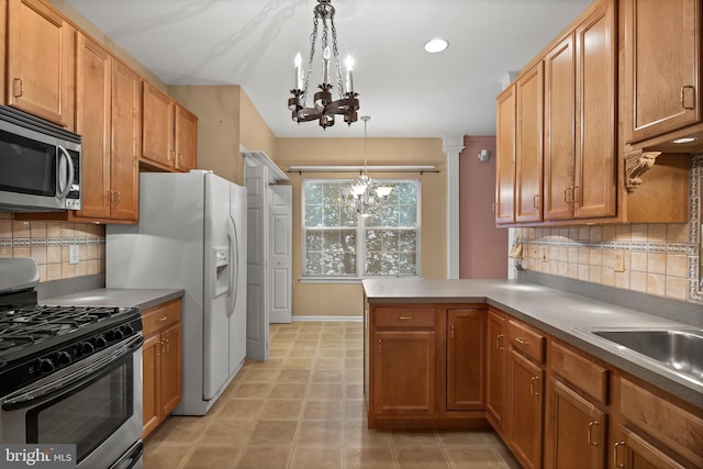 4 Tara Ln, Delran, NJ 08075 - kitchen with appliances with stainless steel finishes, a chandelier, tasteful backsplash, and a peninsula