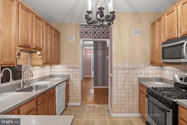 4 Tara Ln, Delran, NJ 08075 - kitchen featuring stainless steel appliances, tile walls, a chandelier, a sink, and light tile patterned flooring