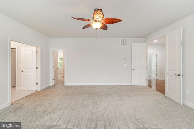 interior space featuring visible vents, baseboards, and ceiling fan