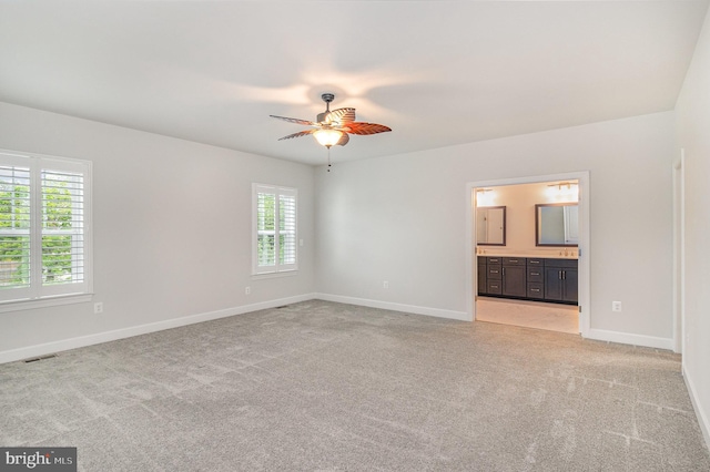 unfurnished bedroom with light carpet, baseboards, visible vents, and multiple windows