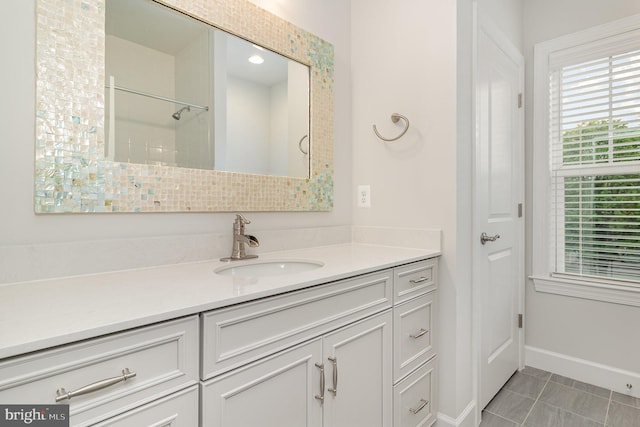 full bathroom featuring baseboards and vanity