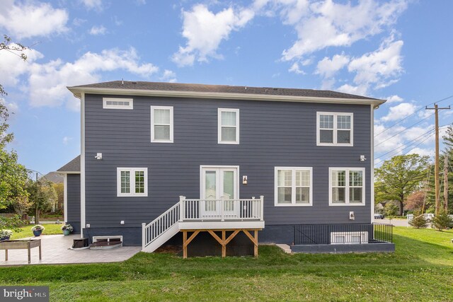 rear view of property with a lawn and a patio
