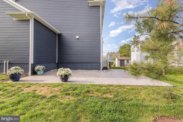 exterior space featuring a patio area and a lawn