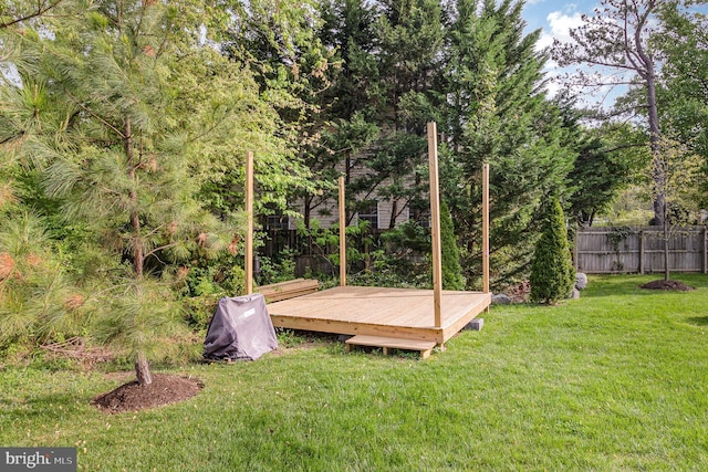 view of yard featuring fence and a wooden deck