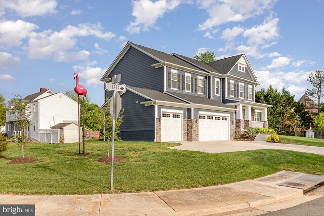craftsman inspired home featuring roof with shingles, stone siding, concrete driveway, a garage, and a front yard
