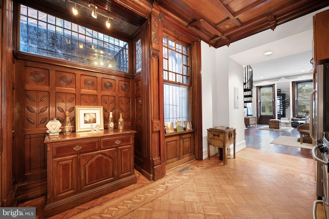 corridor featuring baseboards and parquet floors