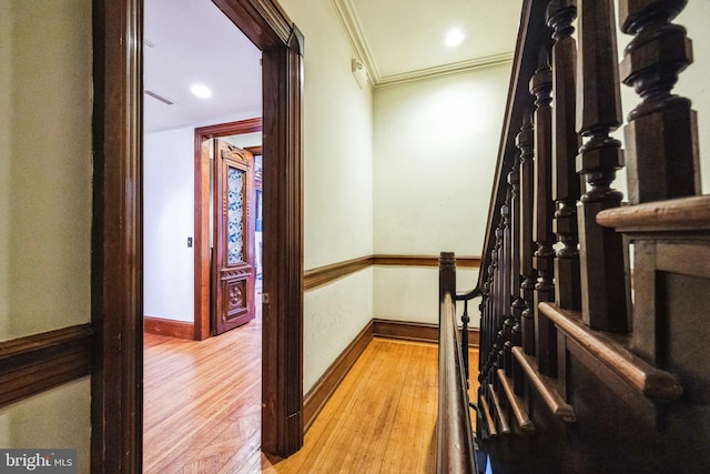 interior space with baseboards, ornamental molding, and wood finished floors