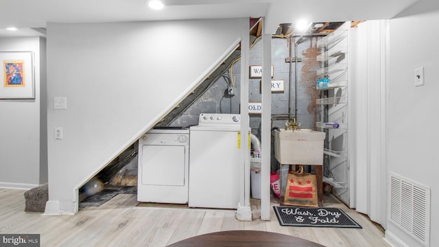 laundry area with washer and dryer, recessed lighting, wood finished floors, and visible vents