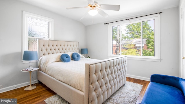 bedroom with baseboards, ceiling fan, and wood finished floors