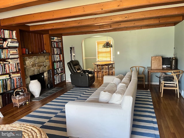 1500 Yardley Newtown Rd, Yardley, PA 19067 - living room with beamed ceiling, a stone fireplace, wood finished floors, and arched walkways