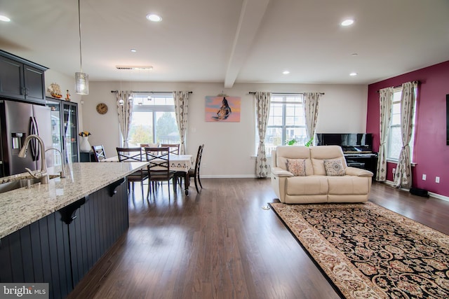 15 N Tompkins Sq, Downingtown, PA 19335 - living area featuring beamed ceiling, a healthy amount of sunlight, and dark wood-style flooring