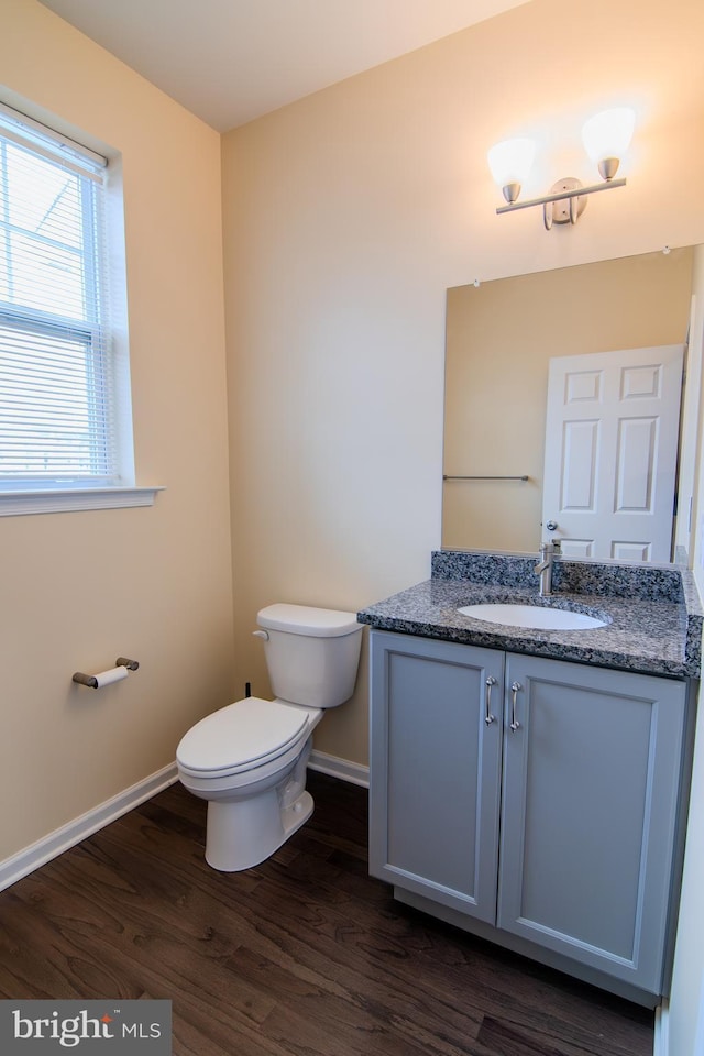15 N Tompkins Sq, Downingtown, PA 19335 - bathroom featuring baseboards, toilet, wood finished floors, and vanity