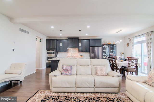 15 N Tompkins Sq, Downingtown, PA 19335 - living area featuring wood finished floors, visible vents, baseboards, recessed lighting, and beamed ceiling