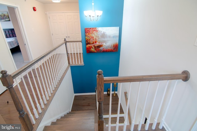 15 N Tompkins Sq, Downingtown, PA 19335 - stairs featuring a chandelier, baseboards, and wood finished floors