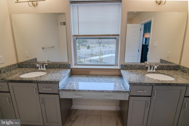 15 N Tompkins Sq, Downingtown, PA 19335 - bathroom featuring two vanities, visible vents, marble finish floor, and a sink
