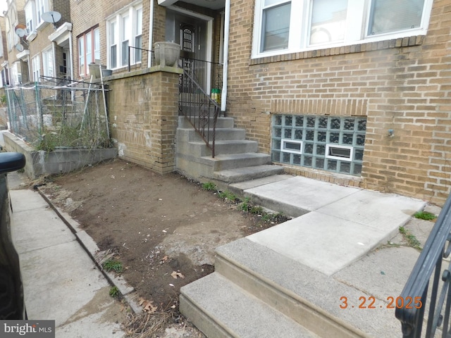 property entrance with brick siding
