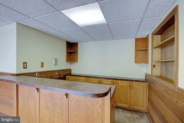 3360 Ben Oak Dr, Huntingtown, MD 20639 - kitchen featuring a peninsula, dark countertops, a drop ceiling, open shelves, and light colored carpet