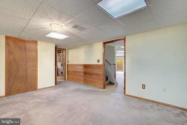 3360 Ben Oak Dr, Huntingtown, MD 20639 - spare room with stairway, carpet floors, wooden walls, visible vents, and a paneled ceiling