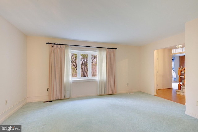 3360 Ben Oak Dr, Huntingtown, MD 20639 - spare room with light colored carpet, visible vents, baseboards, and stairway