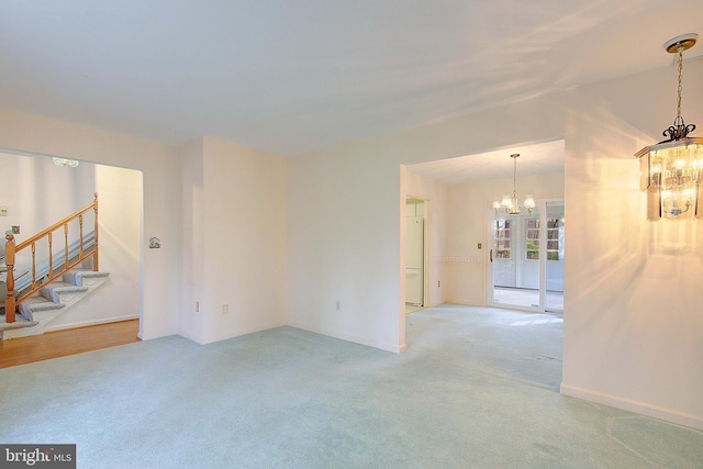 3360 Ben Oak Dr, Huntingtown, MD 20639 - unfurnished room featuring light colored carpet, baseboards, stairway, and a chandelier