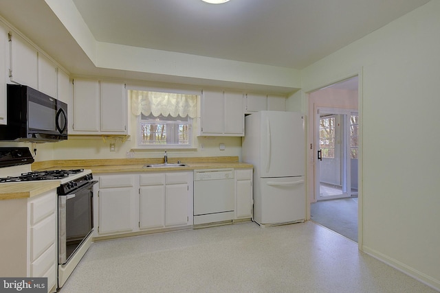 3360 Ben Oak Dr, Huntingtown, MD 20639 - kitchen featuring light countertops, a sink, a healthy amount of sunlight, and white appliances