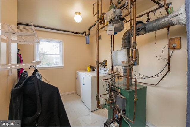 washroom featuring separate washer and dryer, baseboards, a heating unit, and laundry area