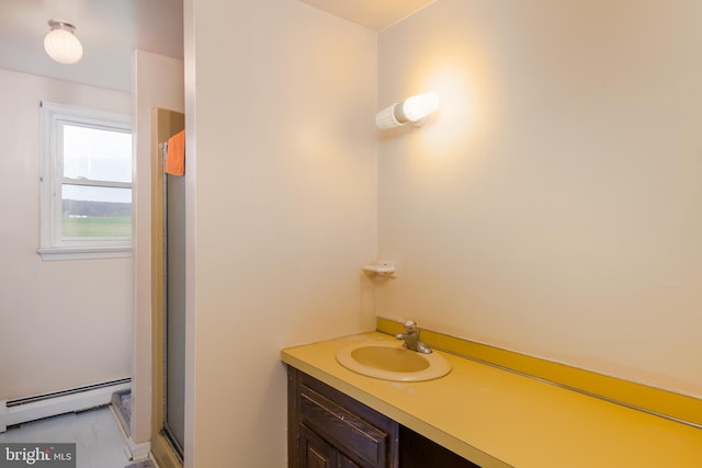 bathroom with a baseboard radiator, vanity, and a stall shower