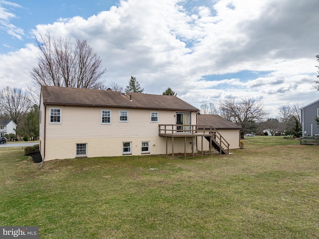 rear view of house featuring a yard, stairway, and a deck