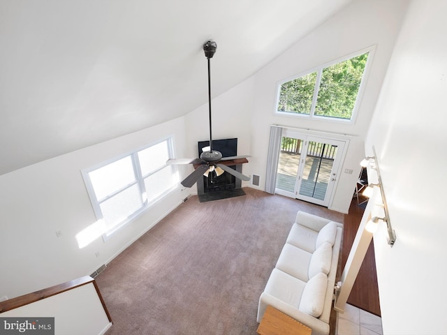 living room featuring carpet floors, ceiling fan, visible vents, and high vaulted ceiling