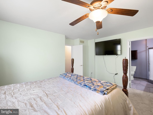 bedroom featuring a ceiling fan, visible vents, and carpet