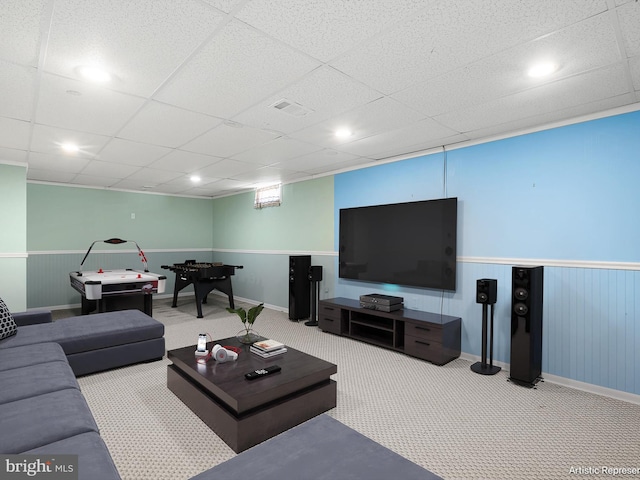 living room with carpet floors, visible vents, wainscoting, baseboards, and a paneled ceiling