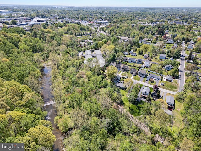 drone / aerial view featuring a wooded view